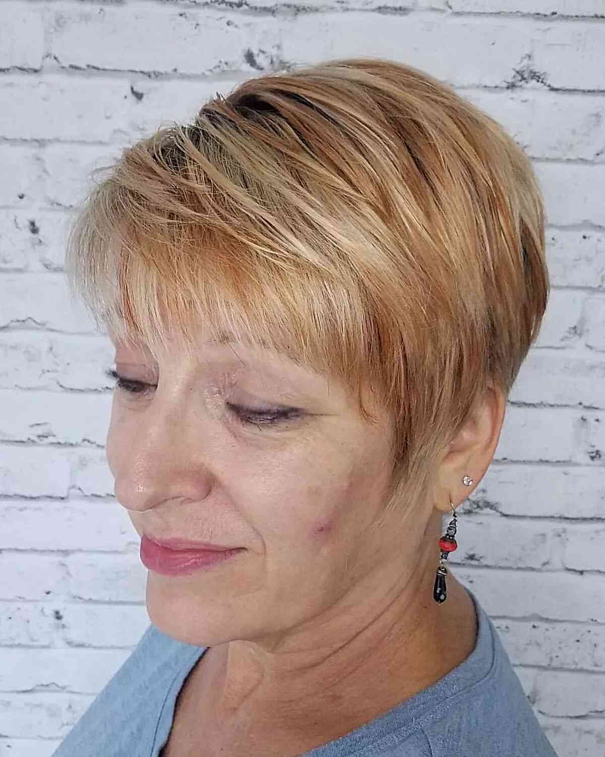 Warm Lowlights on a Layered and choppy Pixie Cut on an older woman with Fine Hair