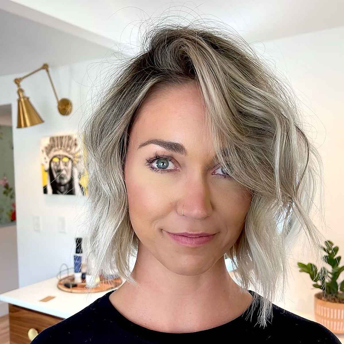 wavy bob with a deep side part and balayage