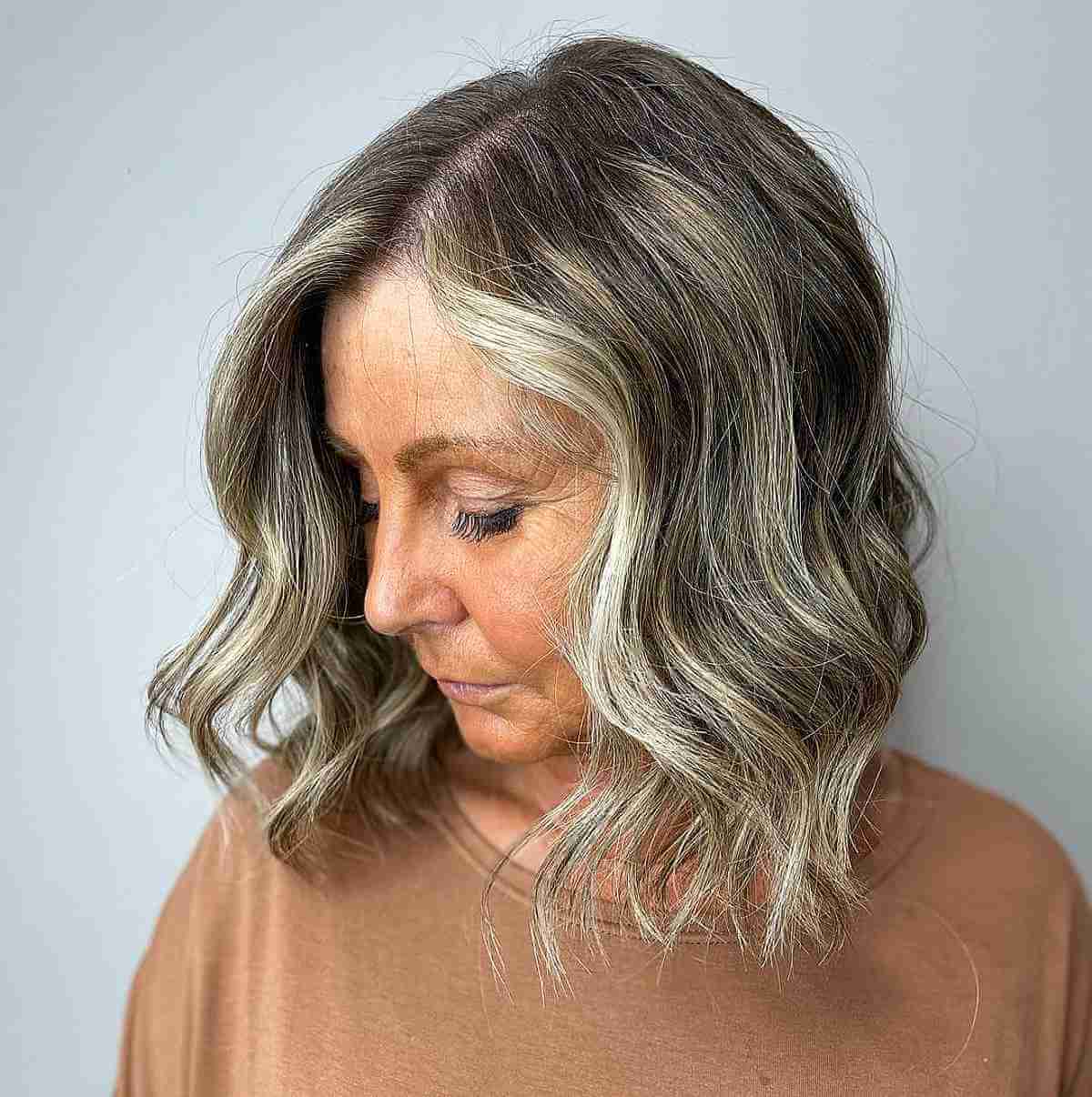 Sassy Wavy Bob with Face-Framing Highlights for an Older Lady