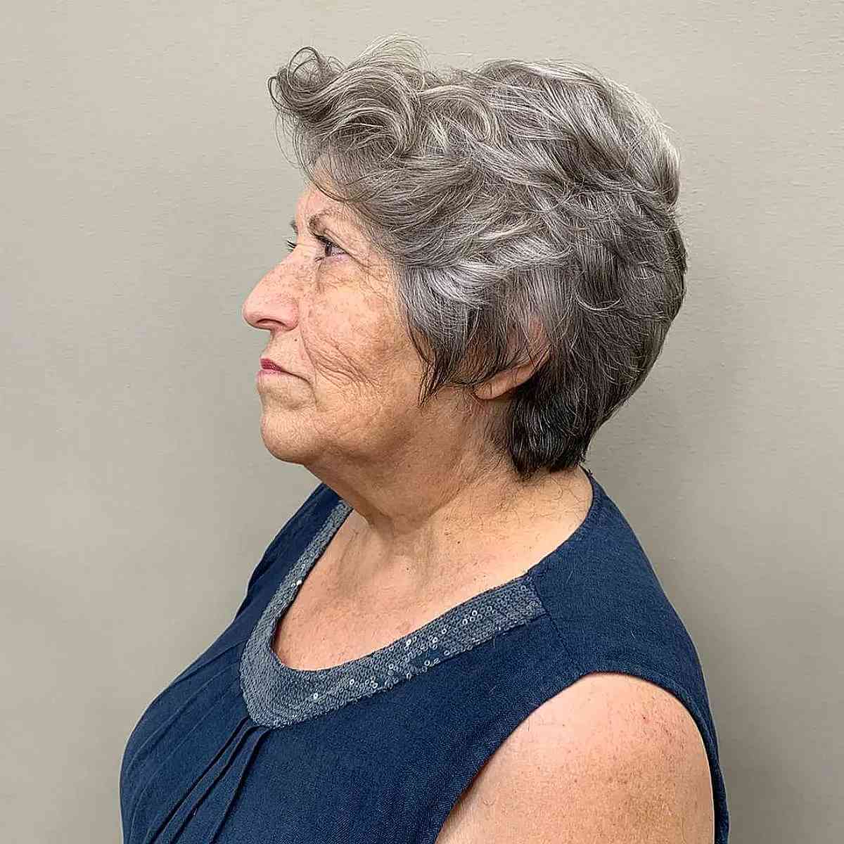 Wavy graduated pixie on gray hair for a woman in her sixties