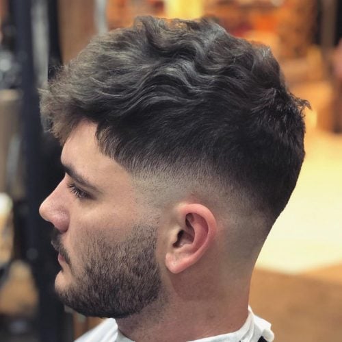 Wavy hair with low skin fade