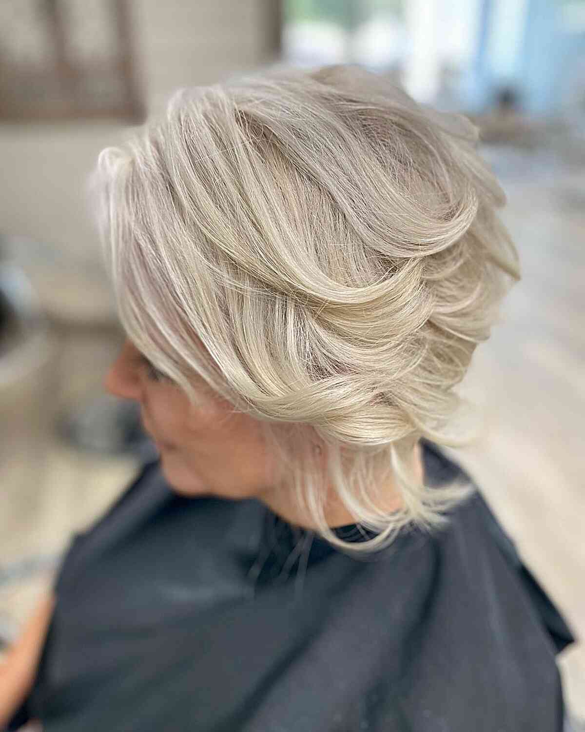 Wavy Platinum Bob with Feathered Flicked Layers for 60-year-old Ladies