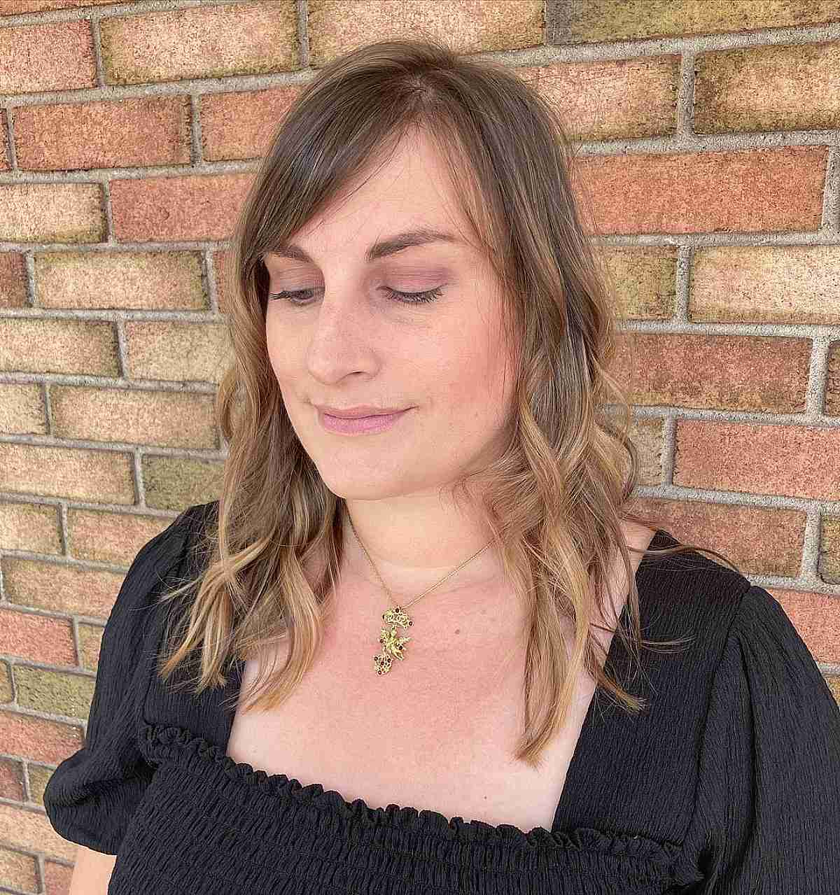 Feminine Wavy Razored Cut with Side Bangs for Thinning Hair