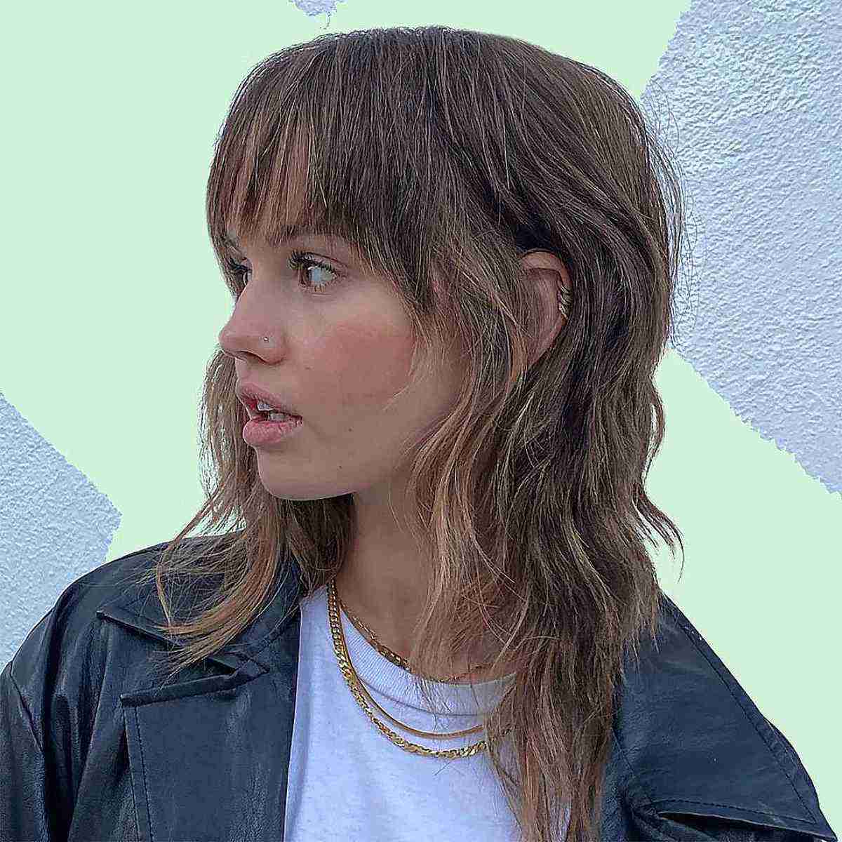 Wavy shag haircut with blunt bangs and choppy layers inclusive hairstyle