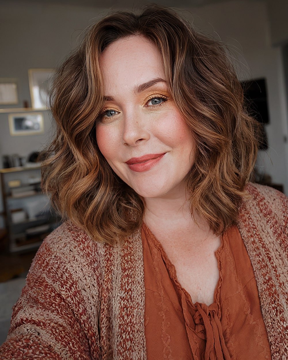Medium wavy shoulder-length cut with off-center part for over 40 women with round faces