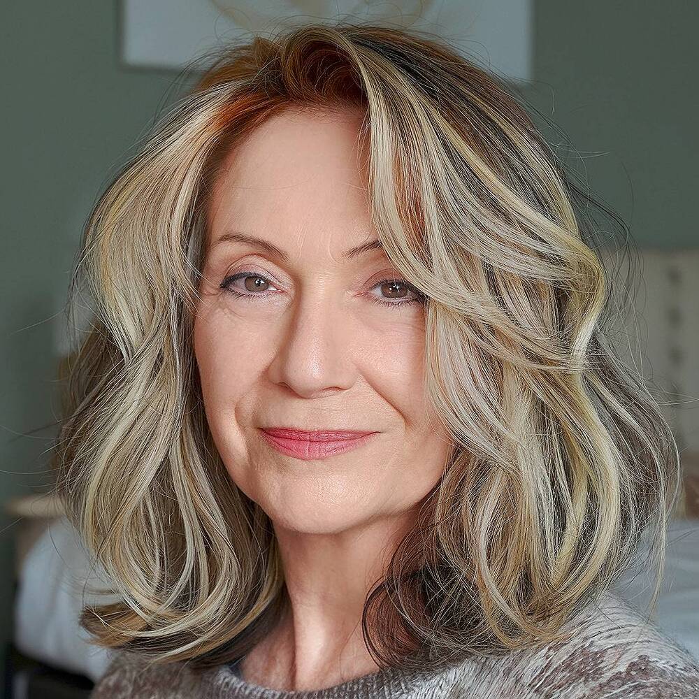 Shoulder-length wavy hair with highlights, adding brightness and movement for women over 60