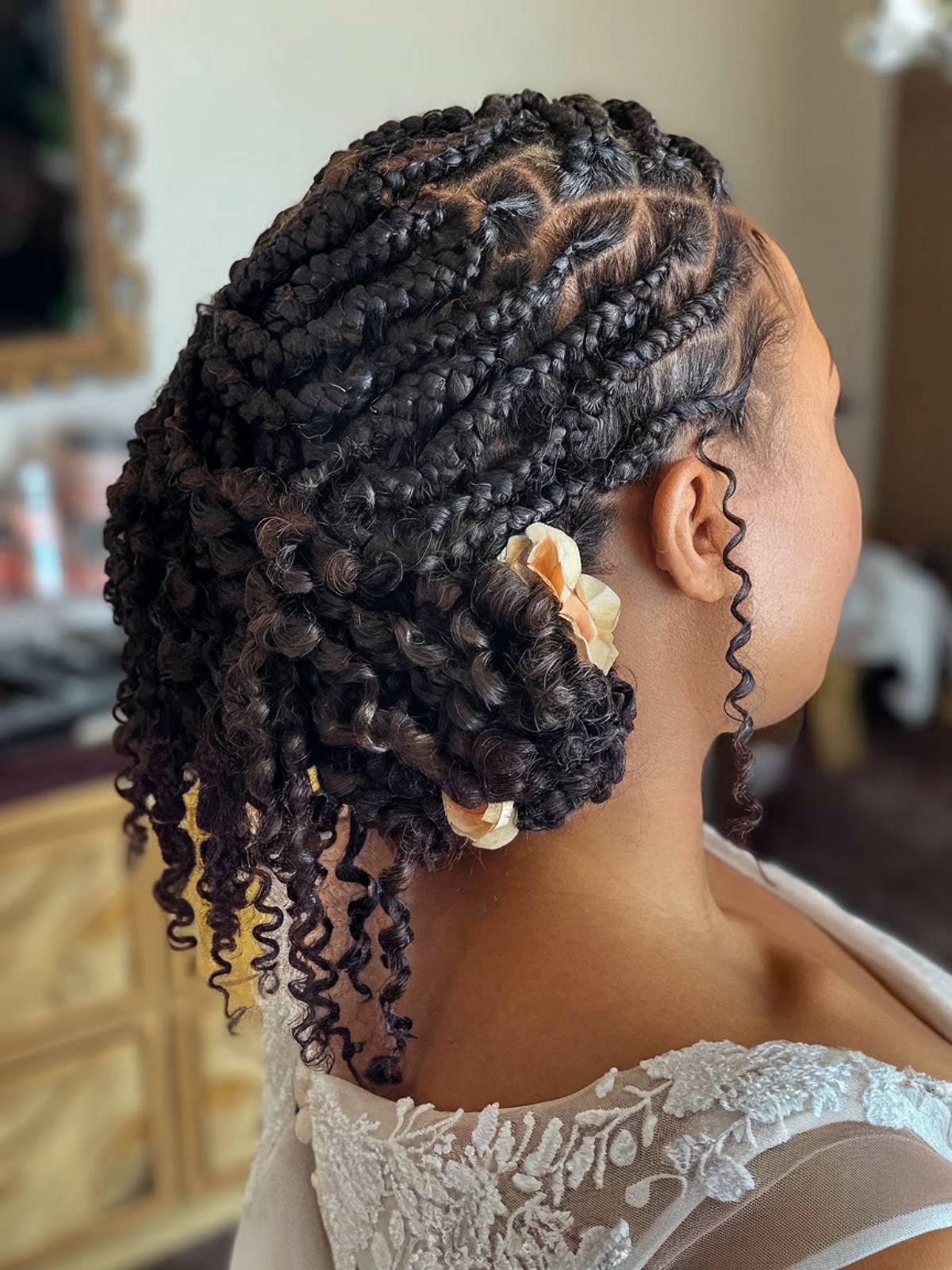 Wedding box braids updo with curls and floral accents