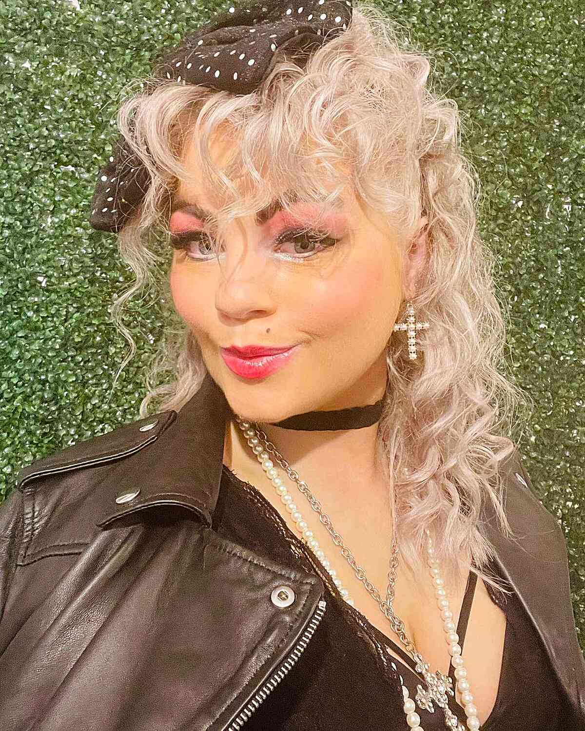 Medium-Length White Blonde 80s Curls with Bangs and Bow