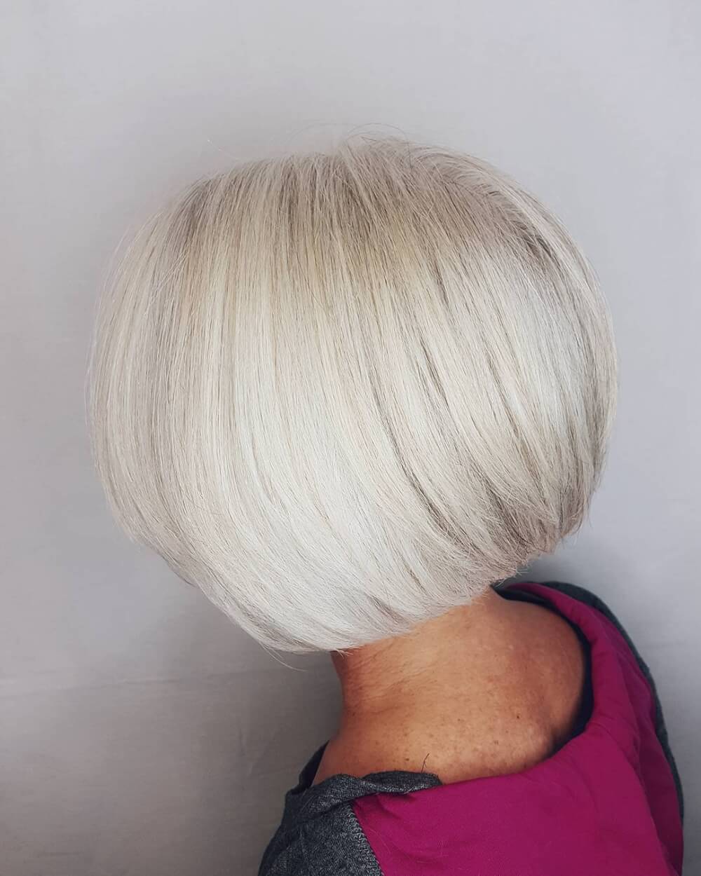 A short rounded bob haircut for women over 60 with grey hair