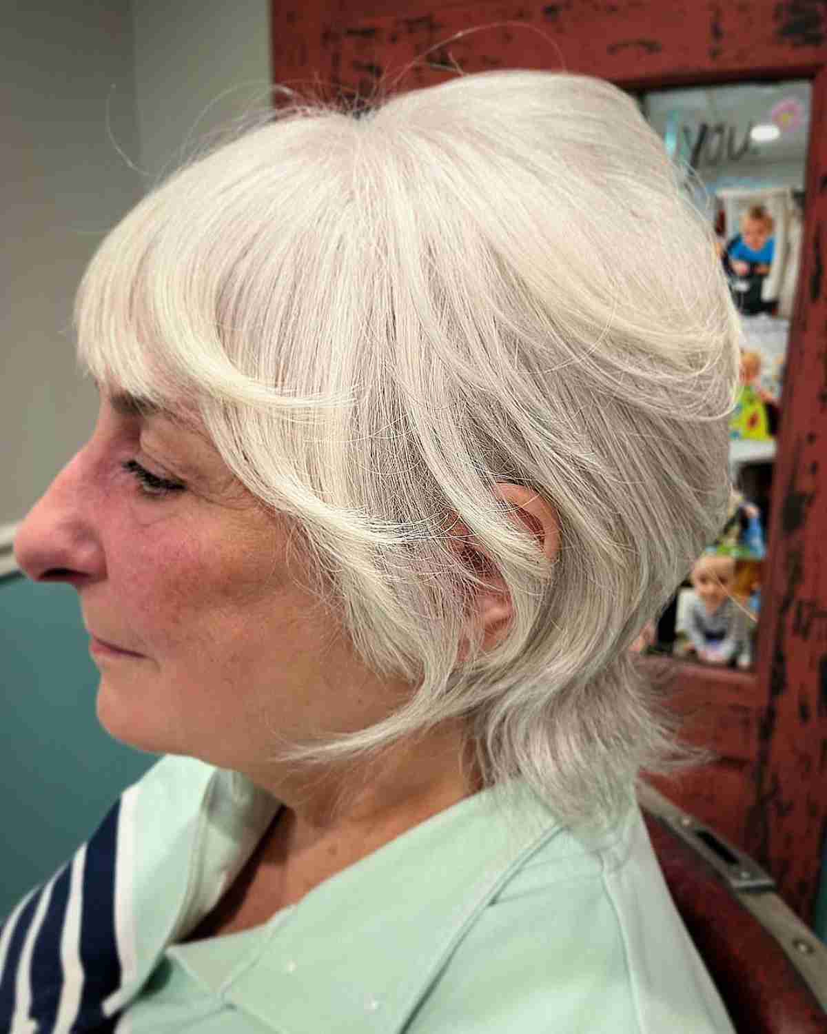White Shaggy Wolf Cut Bob with Face-Framing Layers and Bangs for 70-Year-Olds