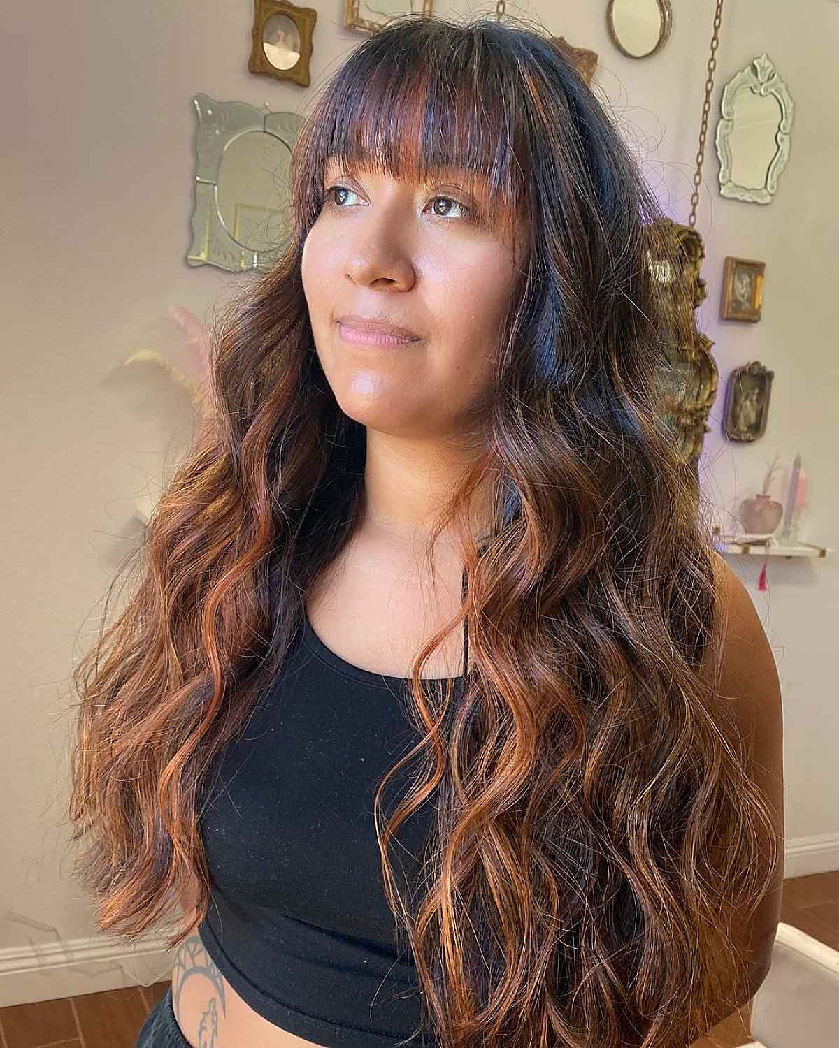 Wispy Bangs and Tousled Waves on Copper Balayage Hair