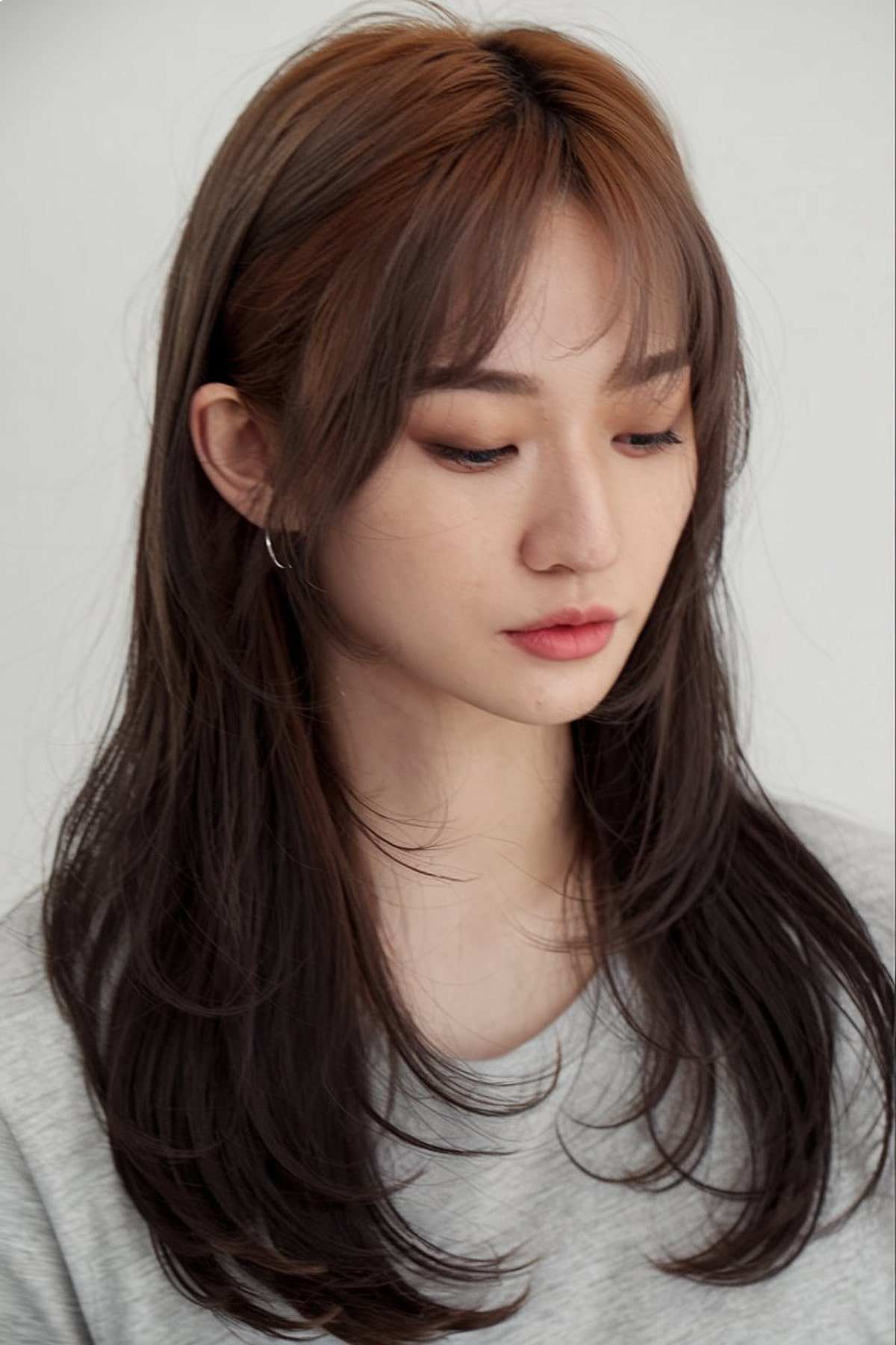 Medium-long hair with wispy bangs for asian women