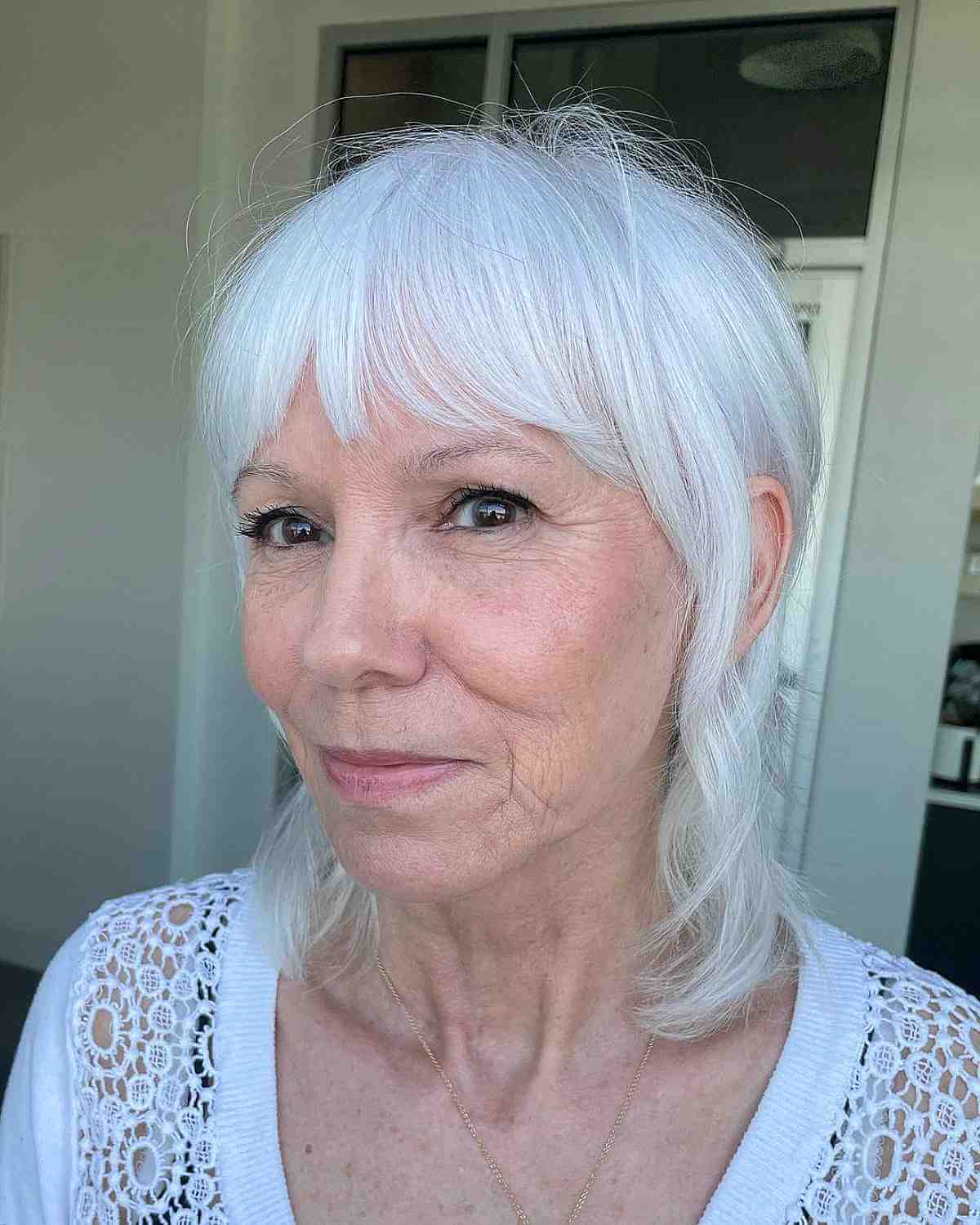 Mid-Length Wispy Shaggy Mullet with Bottleneck Bangs for Women Over 50 with Fine Hair