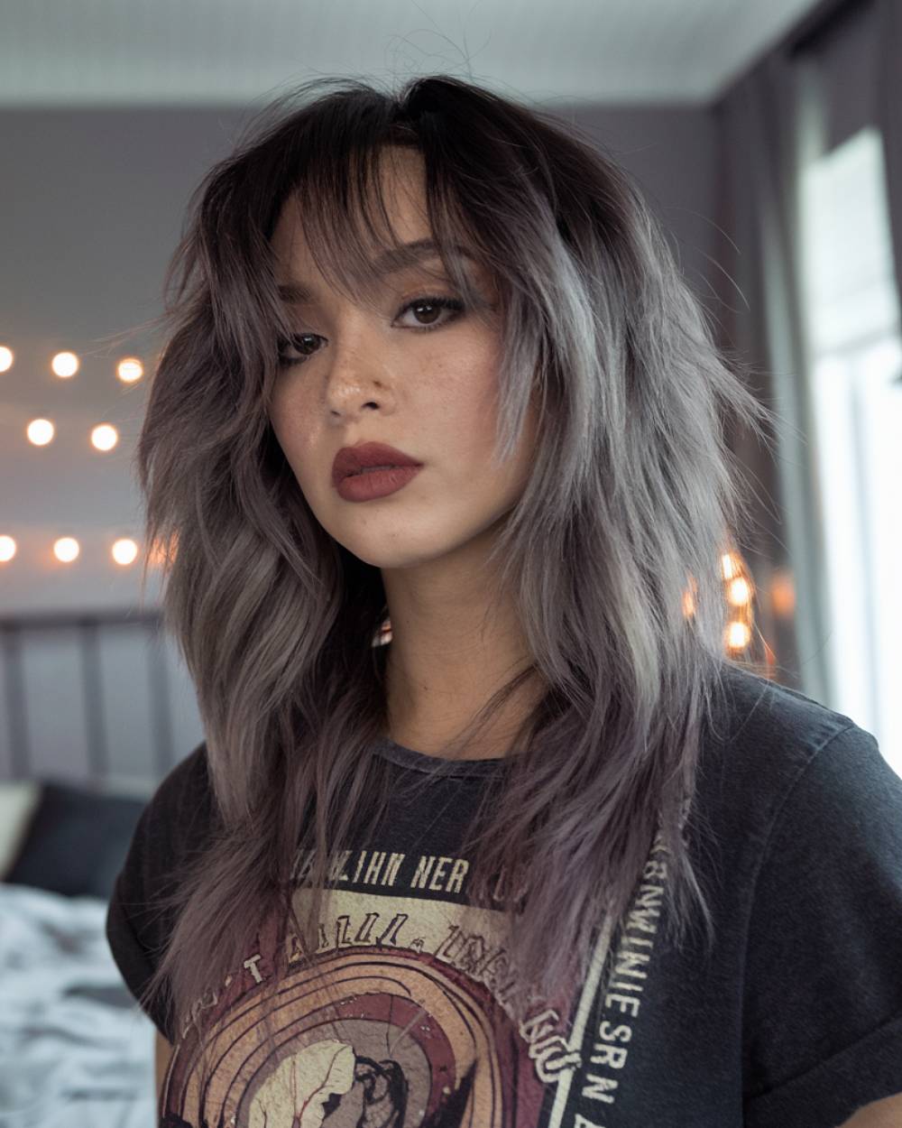 Long wolf cut with textured shaggy layers and curtain bangs on gray ombré hair