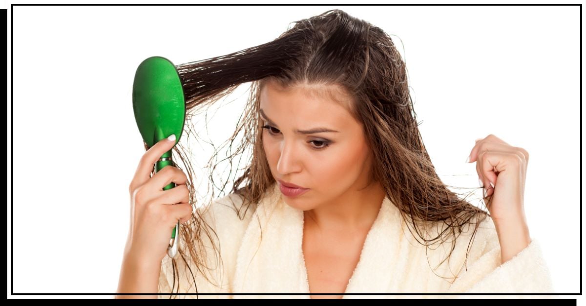Woman combing tangled hair