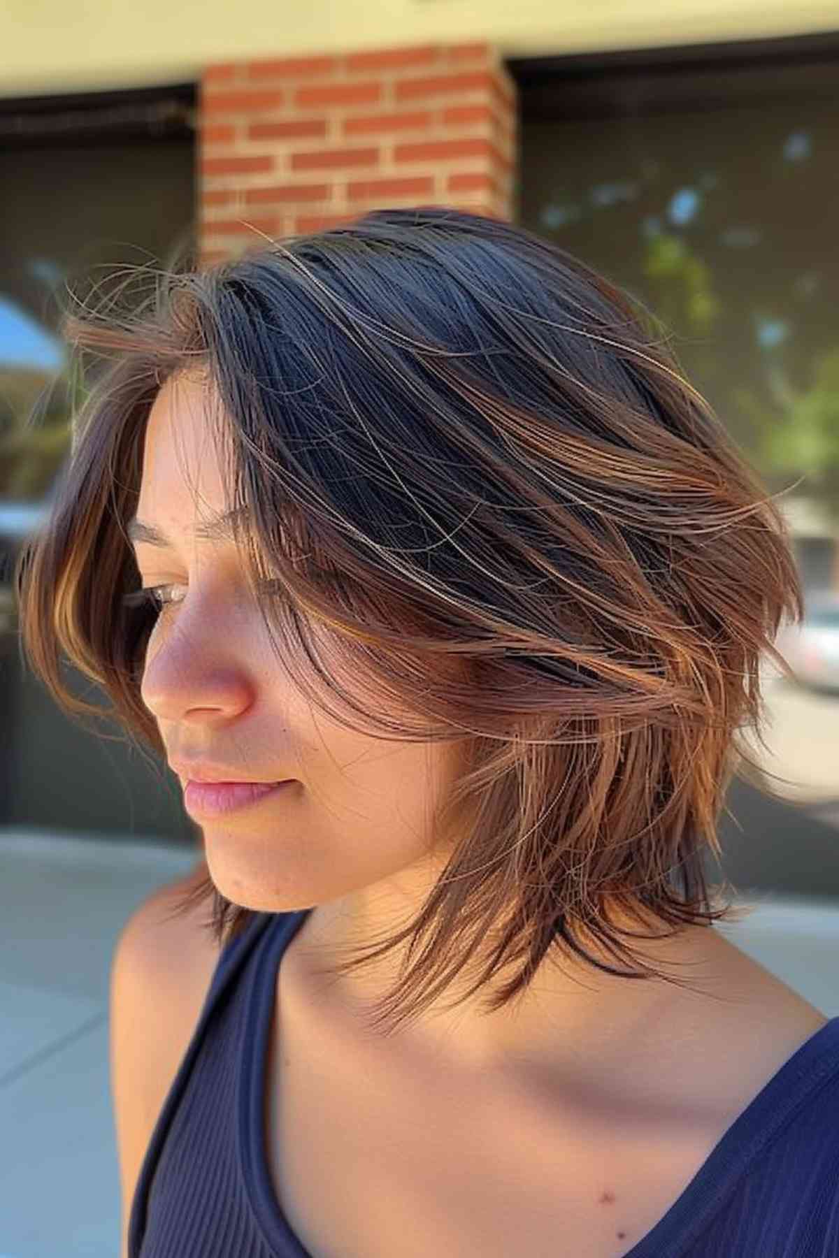 Young Woman with Short Asymmetrical Layered Haircut and Highlights