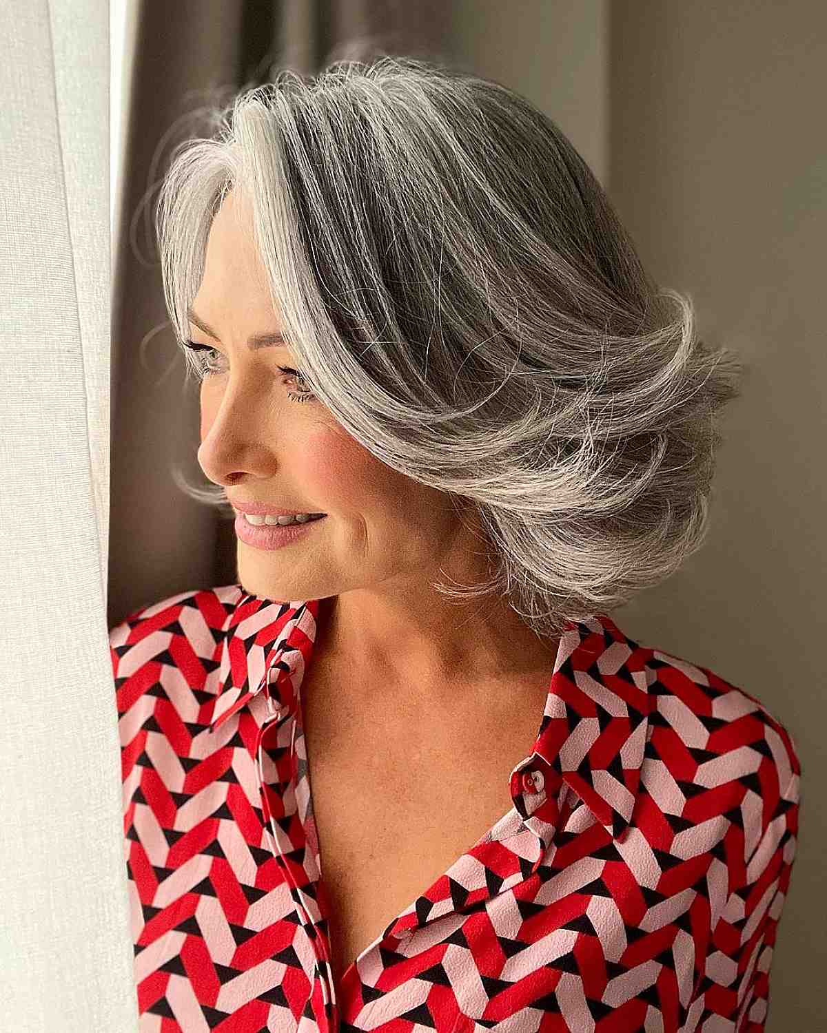 youthful gray bob hairstyle for ladies in their 50s