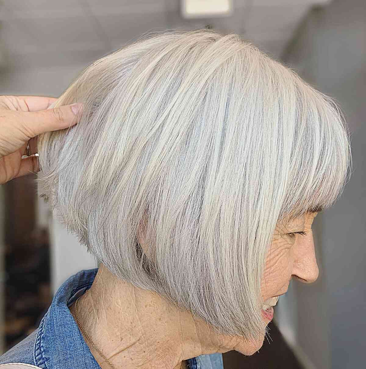 Youthful White Straight Short Bob Cut with Bangs for Women Aged 70