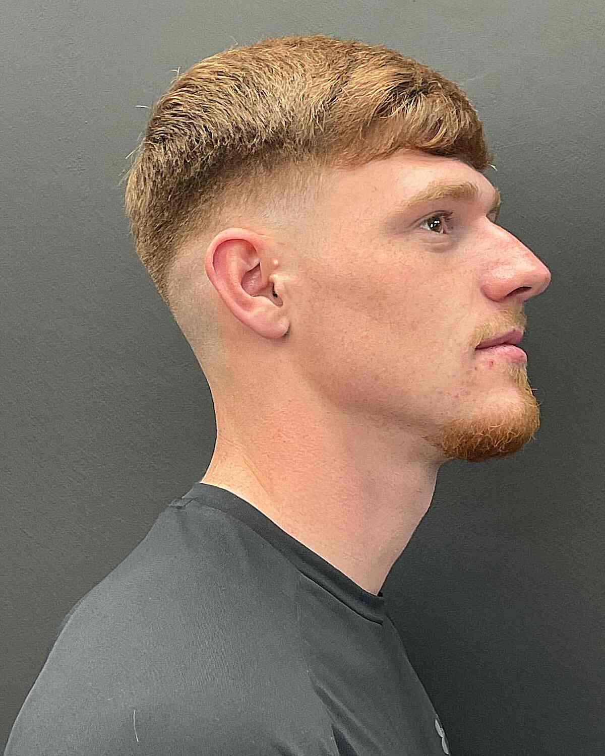 Zero Mid Fade with Textured Short Bangs for Ginger-Haired Men